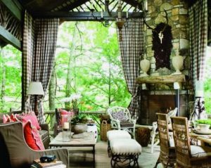 outdoor curtains on a covered patio with fireplace