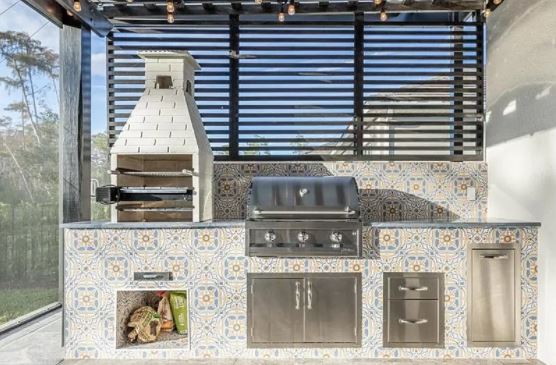 modern outdoor kitchen with grill and pizza oven