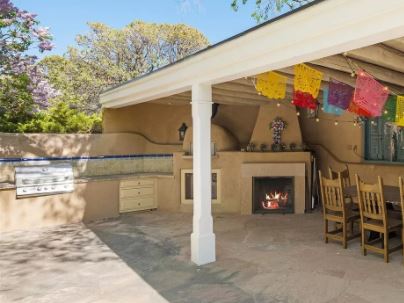 spanish outdoor kitchen with stucco and blue tile border