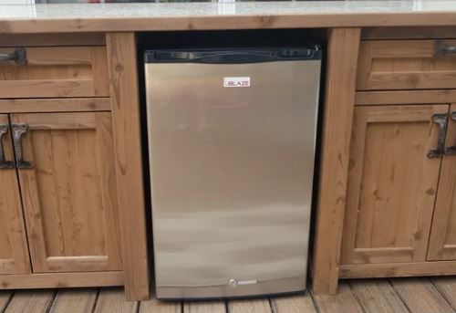 mini fridge in a wood outdoor cabinet