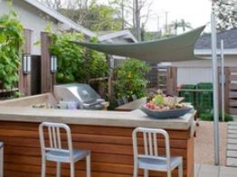 outdoor kitchen covered by shade sail
