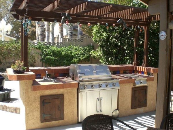 stucco kitchen with rustic wooden cabinet doors and blue tile