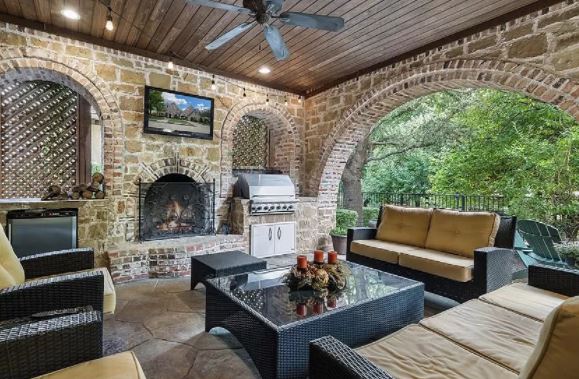 Outdoor living room with outdoor kitchen and outdoor fireplace in Frisco Texas