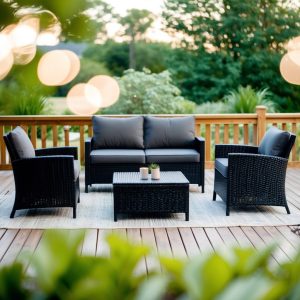 A modern black patio furniture set arranged in a cozy outdoor setting with a table, chairs, and a sleek sofa