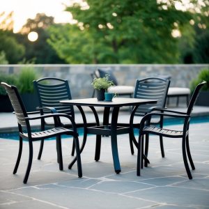 A black patio furniture set, made of durable materials like wrought iron or powder-coated aluminum, is arranged on a stone or concrete patio. The furniture includes chairs, a table, and possibly a lounge or loveseat