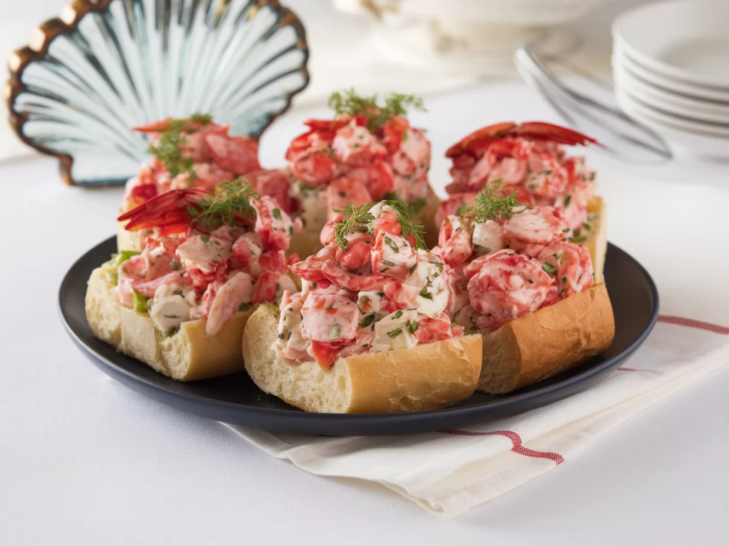 lobster rolls open faced on a blue plate 