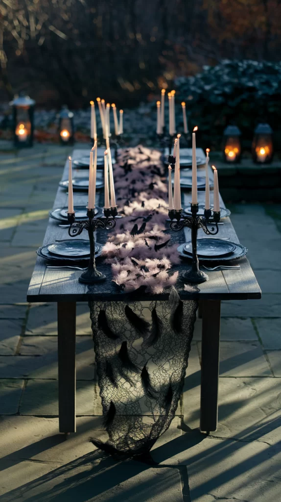 A ghoulish patio table with black candelabra and decorated with black raven feathers.