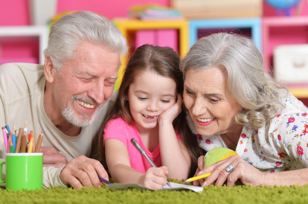 child with grandparents looking at scavenger hunt list